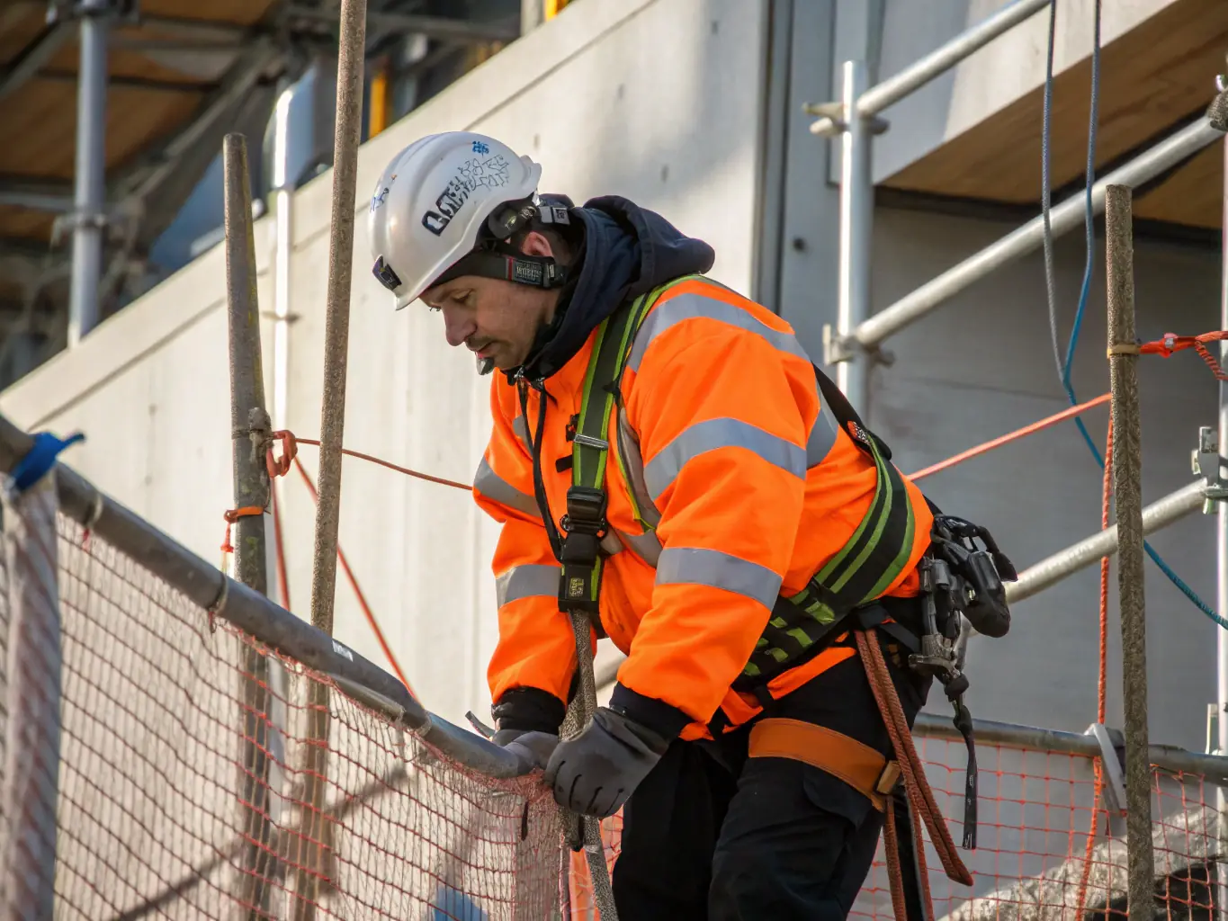 A construction worker wearing an ONYA high-visibility jacket, working near heavy machinery. The jacket is bright and reflective, ensuring the worker is easily seen.